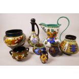 A collection of brightly decorated Dutch Gouda pottery including a Schnapps decanter, vases, jug etc