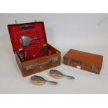 A matched part hallmarked silver mounted vanity set in a fitted leather case, together with a