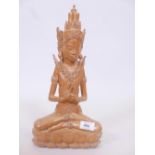 A Balinese boxwood carving of a figure seated in contemplation upon a lotus throne, inscribed to