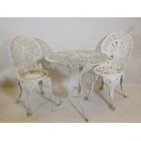 A painted cast aluminium garden table and two chairs, table 25½" high, 27" diameter