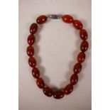 A Baltic amber beaded necklace, 16" long