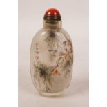 A Chinese reverse painted glass snuff bottle decorated with birds perched on branches, 3" high