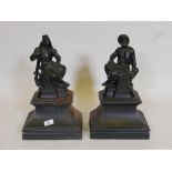 A pair of C19th cast iron fire dogs in the form of a French legionnaire and zouave seated upon