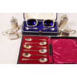 A boxed set of two hallmarked silver table salts with blue glass liners and spoons by Mappin and