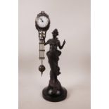 A bronzed metal mystery clock in the form of a woman in classical attire, 13½" high