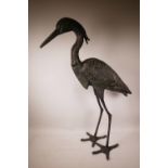 A bronzed metal garden figure of a heron, 33" high