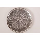 A Chinese white metal dish with raised decoration of two dragons and an auspicious character, 4"