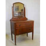 An Arts and Crafts oak dressing table with carved decoration, 31" x 17", 57" high