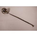 A Georgian silver brandy ladle with twisted whalebone handle and coin inset bowl, 13½" long