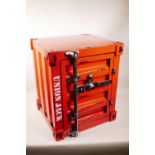 A metal cabinet in the form of a shipping container with distressed paintwork, 15" x 16", 19" high