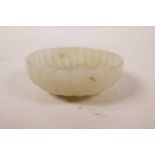 A Chinese white jade brush wash of carved, lobed form, 2½" diameter