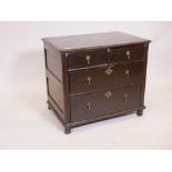 A Queen Anne oak chest of drawers, with panelled sides and plank top, and two over two drawers,