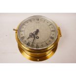 A Mercer brass cased ship's bulkhead clock with engraved silvered dial and black Roman numerals,