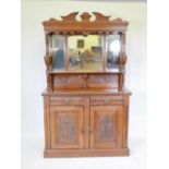 A Victorian walnut mirror back sideboard with two drawers over two doors and carved decoration,