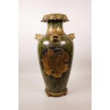 A large Chinese mottled green glazed pottery vase with ormolu style mounts and lion mask handles,