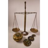 A C20th brass balance scale, a brass pomander and a horse brass