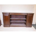 A Victorian walnut breakfront low bookcase, with ebonised and parcel gilt decoration in the
