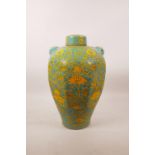 A Chinese pottery jar and cover of octagonal form with two mask handles, green and yellow