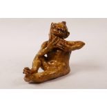 A grotesque pottery figure of an imp with pan pipes, 4" high