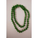 A string of apple green jade beads, 33" long