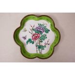 A Canton enamelled copper dish with a frilled rim, decorated with flowers and butterfly, 5" diameter