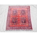 A Persian tomato ground square rug with stylised medallion decoration, 62" x 67"