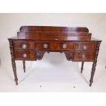 A Regency flame mahogany sideboard with upper shelf, three drawers and fitted cellarette, carved