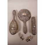 A sterling silver dressing table set consisting of a hallmarked mirror and two brushes, Broadway and