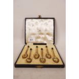 A set of six sterling silver coffee bean spoons with gilt bowls and enamel backs, hallmarked