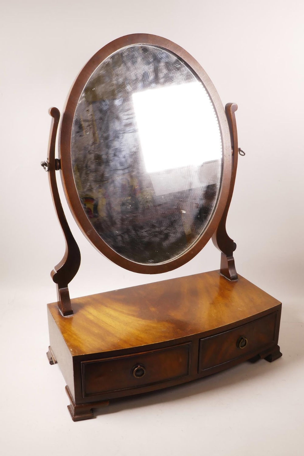 A Regency style mahogany swing toilet mirror, 17" wide, 25" high