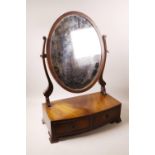 A Regency style mahogany swing toilet mirror, 17" wide, 25" high