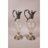 A pair of WMF claret style oil and vinegar cruet bottles with spiral glass reservoirs and