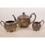 A C19th Regency style silver plated three piece tea set with ribbed and classical swag decoration