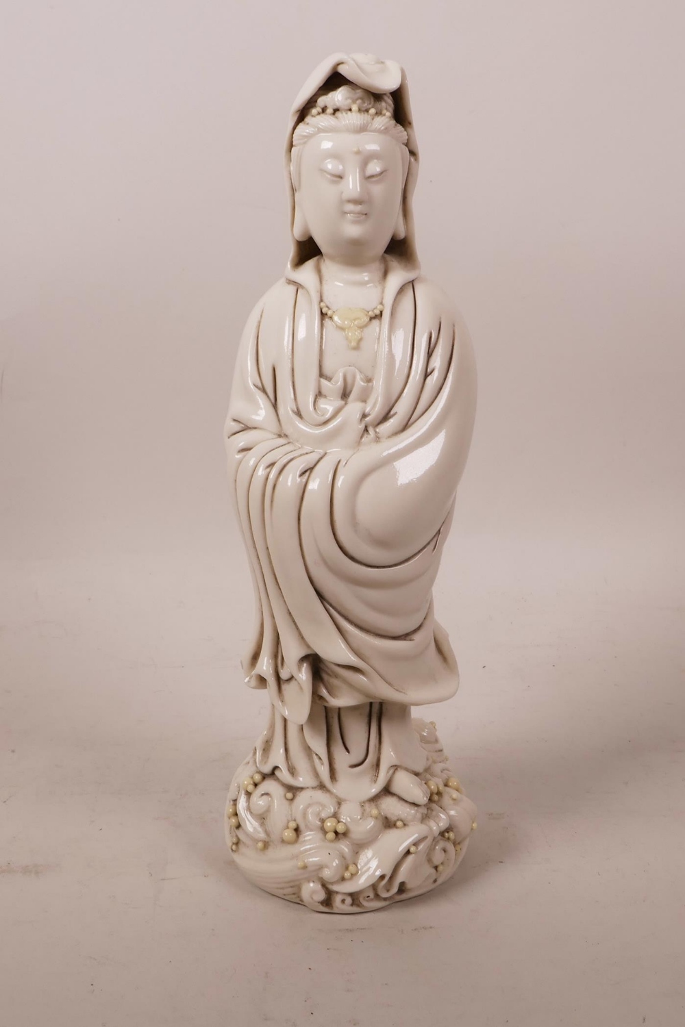 A Chinese blanc de chine figure of Quan Yin, impressed mark verso, 9½" high