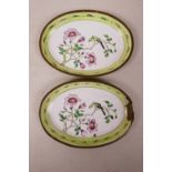 A pair of Canton enamelled copper oval dishes, decorated with birds on a branch in bloom, A/F