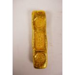 A Chinese gilt white metal trade token/ingot, 4" long, 190 grams