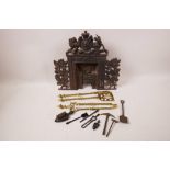 A Victorian cast iron doll's house fireplace, 12" x 11", together with a set of three miniature