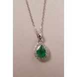 An 18ct white gold, pear shaped emerald and diamond pendant necklace, approximately 90 points
