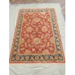 An Oriental style deep pile wool carpet decorated with an all over floral pattern, made with New