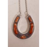 A sterling silver horseshoe necklace set with agate, 1" x 1½"
