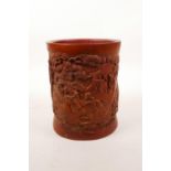 A Chinese bamboo brush pot with carved decoration of the Eight Immortals in a landscape, 6½" high