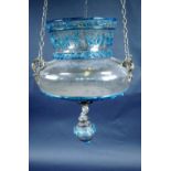 An Islamic glass hanging lantern with overlaid blue glass decoration and script, 12" diameter