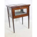 A vintage mahogany rise and fall spirit cabinet, the top opening and raising the tray and holders