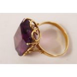 An 18ct yellow gold ring set with a large amethyst, 9 grams total, size 'T'