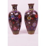 A pair of cloisonné vases decorated with symbols on a black ground, 7½" high, A/F