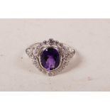 A silver and cubic zirconium dress ring with a large central amethyst, approximate size 'N'