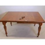 A Victorian light walnut dining table, raised on turned supports, 42" x 42" x 59" extended