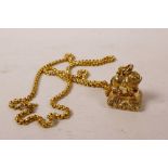 A gilt metal seal with a lion knop, on a gilt chain, 1" x 1"