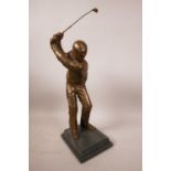 A bronzed composition golf trophy cast as a golfer driving off, numbered 45/150, 14½" high
