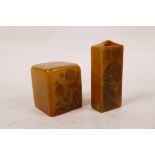 A Chinese amber soapstone seal, and another with engraved floral and landscape decoration,